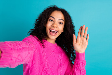 Portrait of nice young girl take selfie arm wave hi wear pink pullover isolated on turquoise color background © deagreez