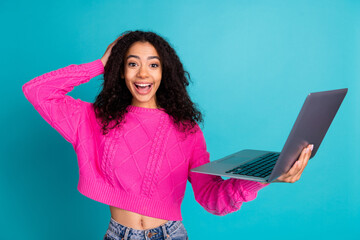 Photo portrait of lovely teen lady hold netbook excited dressed stylish pink garment isolated on cyan color background