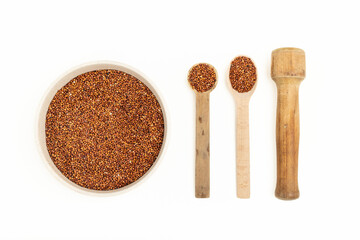 Chia seeds in a plate and wooden spoons on a white background