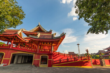 Cheng ho temple at semarang ; semarang tourism ; Majestic Traditional Temple Architecture Under a Clear Blue Sky, Framed by Lush Greenery