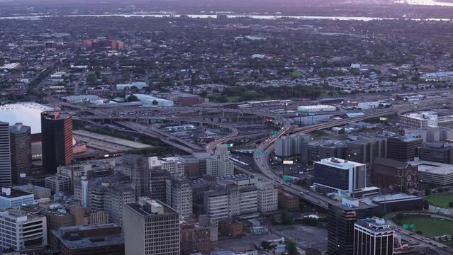 Aerial view of downtown new orleans at dusk, featuring the skyline, mississippi river, Superdome multi purpose stadium, and highway interchange
