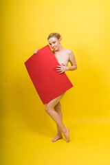 Blonde model, Young woman holding a cardboard cloud red sheet of papaer, a place for an inscription