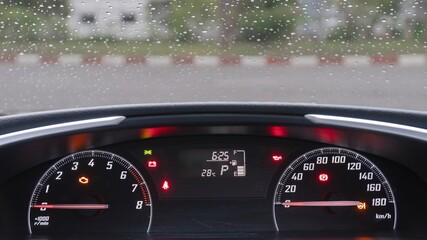 Car dashboard with speedometer and tachometer.
