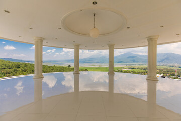 Obraz premium Luxurious Open Pavilion Overlooking Vast Green Landscape and Distant Mountains, Perfect Serenity