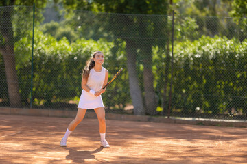 A woman is playing tennis on a court