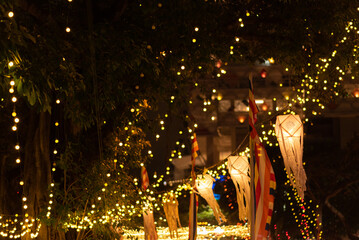 Vesak lanterns at night with light bokeh in background