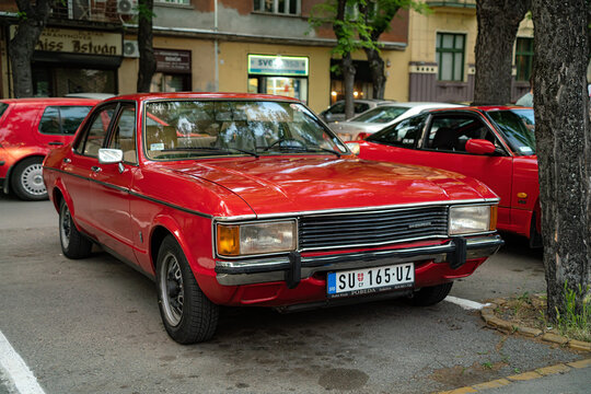 Ford Granada I four door sedan  (first generation)  in red color is parked in Subotica, Serbia, 18.05.2024