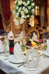 Decor for a wedding or engagement party. Decorated and set tables for the guests of the holiday