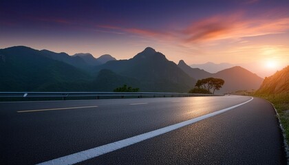 Asphalt road and beautiful mountain with lake at sunset