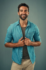 Denim, fashion and funny with portrait of man in studio on gray background for relaxed clothing...