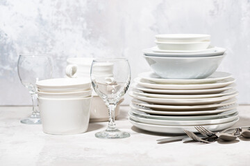 tableware, cutlery and glasses on a white background