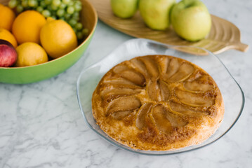 Homemade baked apple pie on a glass plate on a tabletop