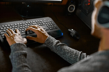 Man, gaming and typing on keyboard with headsets in home, cyber and esports hobby for online...