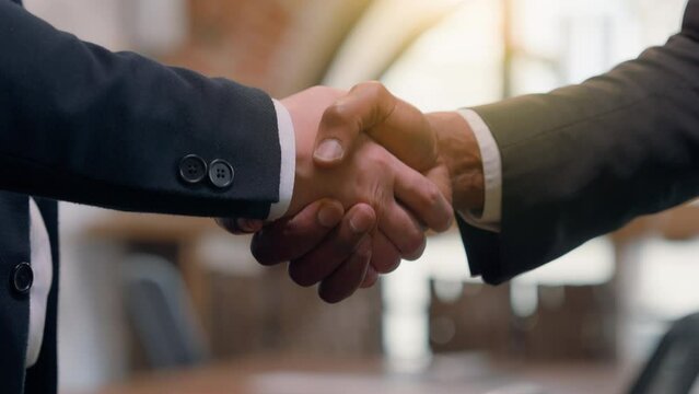 Close up two success businessmen multiracial diversity multiethnic business people partners partnership teamwork cooperation deal greeting welcome office hire African Asian men handshaking shake hands