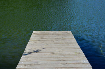 Fototapeta premium a wooden dock in the water isolated copy space 