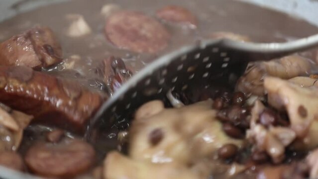 Traditional and irresistible Brazilian feijoada closeup