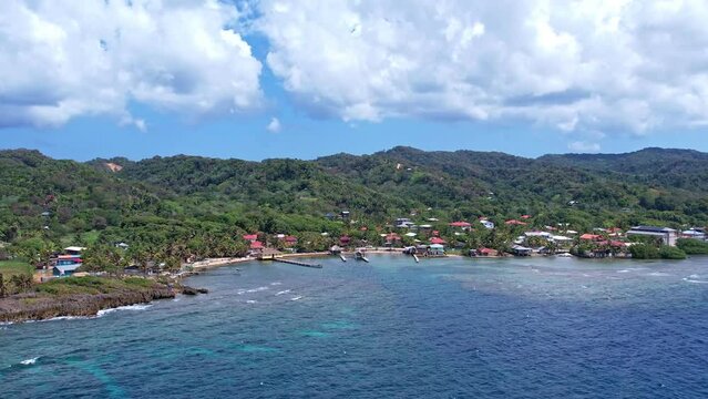 4k resolution drone video of buildings and homes on the coastline of roatan honduras in the caribbean

