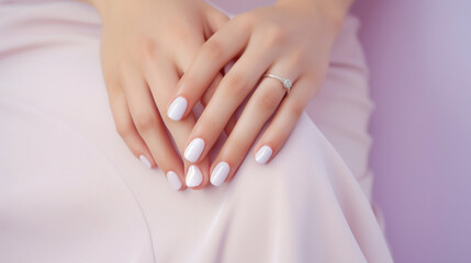 Fototapeta premium Female hands with delicate nails painted with soft pastel shades against a pastel background