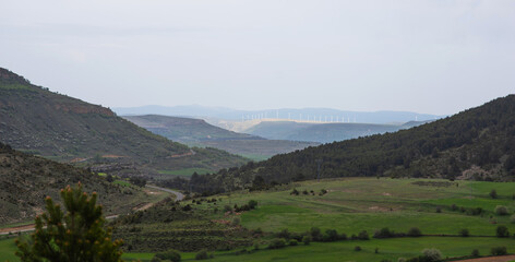 Misty rural landscape at sunrise in Tarragona, Spain. Green fields and mountains on the background. Ecology concept. View of the agricultural landscape. Rural landscapes and nature.