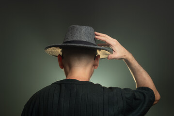 Mysterious, middle-aged man wearing a hat on his head. Photo in studio.