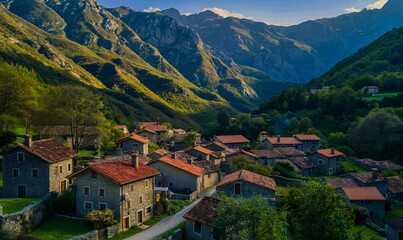 Fototapeta premium AI generated illustration of a quaint mountain village with a towering peak in the background