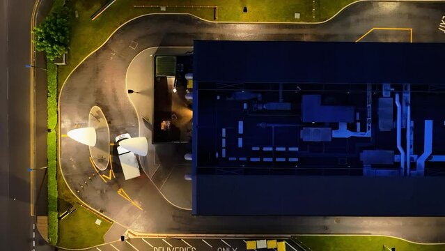 Top down view of car going through fast food restaurant at night