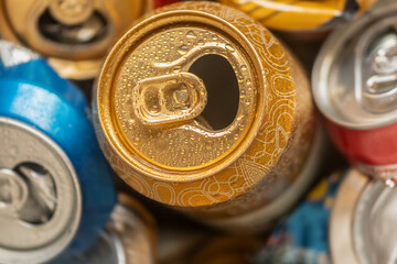 Crumpled wet beer cans with water drops