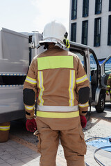 Fireman helping people in damaged car staged training fire fireman at work action