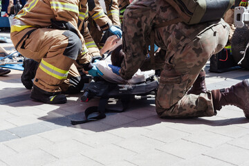Fireman helping people in damaged car staged training fire fireman at work action