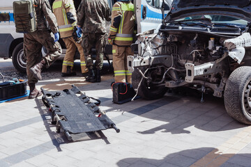 Fireman helping people in damaged car staged training fire fireman at work action