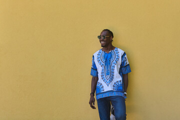 Sudanese Tradition Meets Modern Youth: African American Teen in Vibrant Traditional Attire Against...
