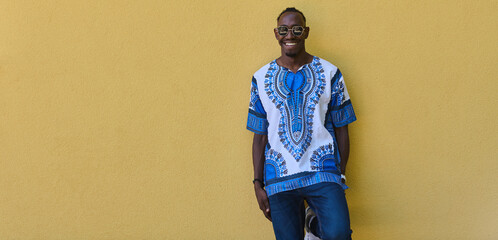 Sudanese Tradition Meets Modern Youth: African American Teen in Vibrant Traditional Attire Against...