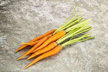 Young raw carrot heap isolated