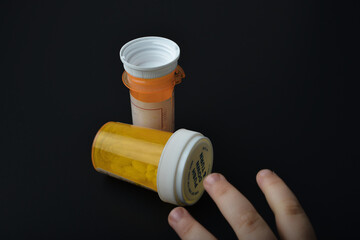 child trying to grab a child proof pill bottle