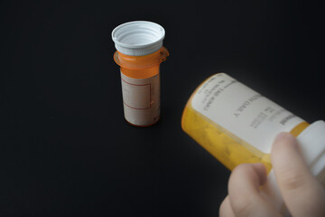 child trying to grab a child proof pill bottle