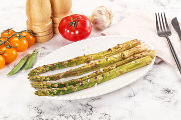 Grilled asparagus sprouts served red pepper