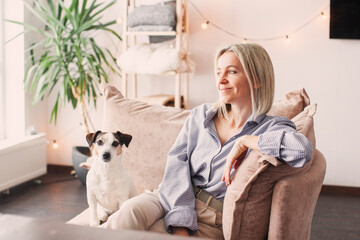 Cut Middle aged Woman sitting on couch at home