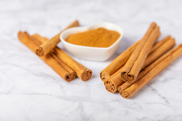 Ceylon cinnamon.Cinnamon sticks on a textured wooden background. Cinnamon roll and powder. Spicy spice for baking, desserts and drinks. Fragrant ground cinnamon. Close-up. Place for text. copy space