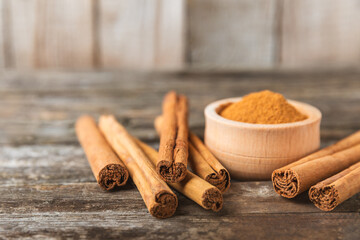 Ceylon cinnamon.Cinnamon sticks on a textured wooden background. Cinnamon roll and powder. Spicy spice for baking, desserts and drinks. Fragrant ground cinnamon. Close-up. Place for text. copy space