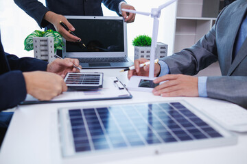 architects and investors discuss real estate projects using clean energy or solar cells within...