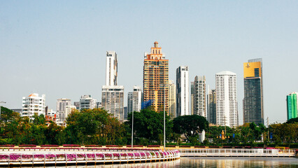 Modern Urban Skyline with High-Rise Buildings and Waterfront Promenade on a Clear Day