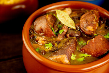 Brazilian Feijoada Food black bean stew with bacon and pork sausage close up