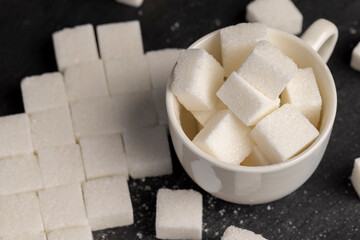 white square sugar on a black background