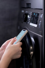 Smartphone with app used to control washing machines
