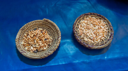 Detailed view of shelled argan nuts arranged in handcrafted baskets. A glimpse of Moroccan culture,...