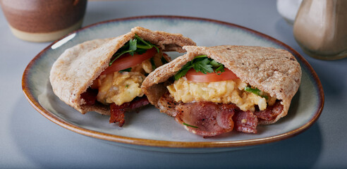 Pitta bread filled with bacon,scrambled eggs,tomato and parsley.