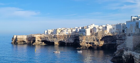 Obraz premium White Buildings on the Rocky Coastline of Polignano a Mare, Italy