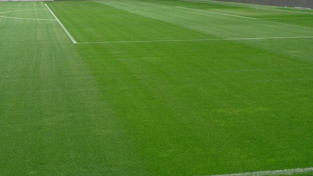 Soccer field stadium or football lawn with green grass, artificial turf panoramic view