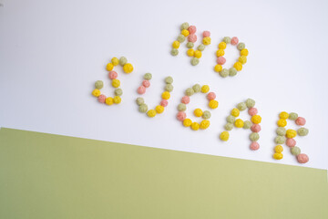 Words NO SUGAR made from colored flakes on a light background. Diet healthy nutrition concept

