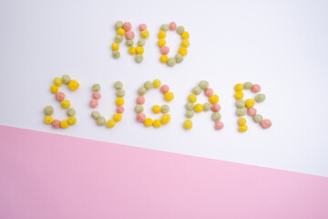 Words NO SUGAR made from colored flakes on a light background. Diet healthy nutrition concept